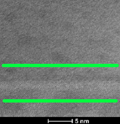 High-resolution TEM image of a silicon interface showing thin film layers with atomic precision, scale bar 5 nm