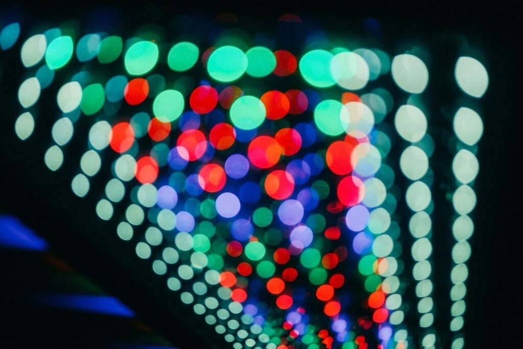 Abstract blurred image of multicolored LED lights arranged in patterns, representing digital display or photonics technology